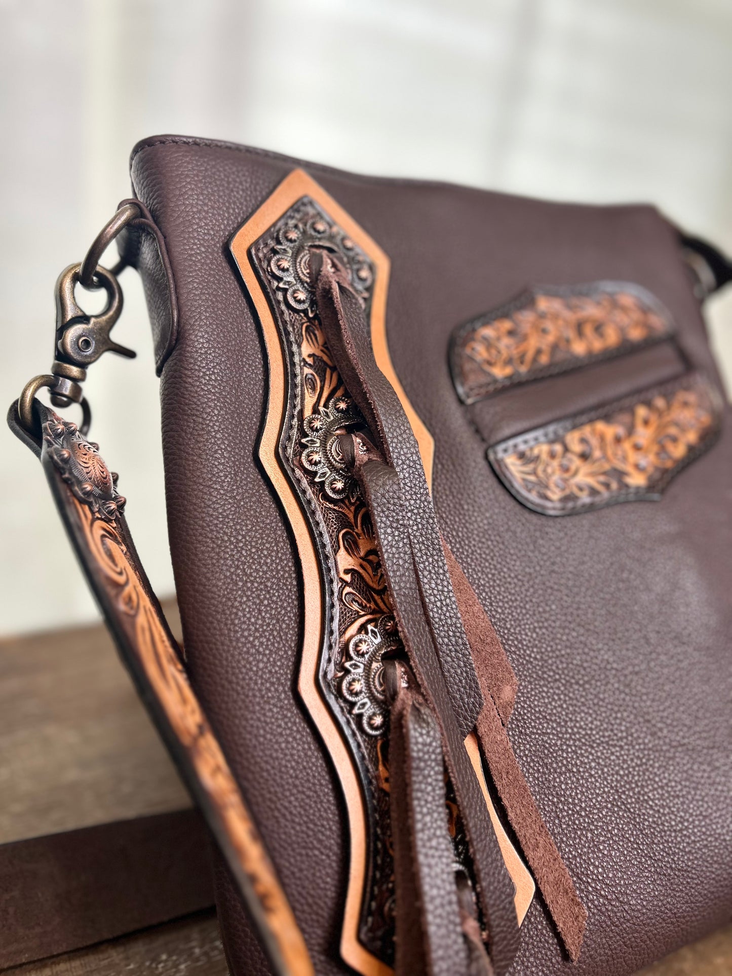 Concho Leather Crossbody with tooling and fringe accents