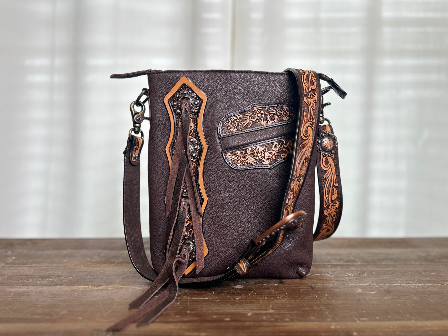 Concho Leather Crossbody with tooling and fringe accents